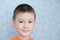 Sly adorable boy at 7 age portrait closeup, Caucasian child smiling happy