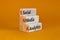 SMA social media analytics symbol. Wooden blocks with word `SMA social media analytics` on beautiful orange background, copy spa