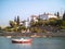 Smail boat anchored below island houses