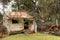 Small abandoned and derelict timber weaterboard hut