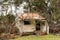 Small abandoned and derelict timber weaterboard hut