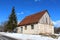 Small abandoned stone house with tall pine