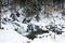 A small active waterfall. Clean mountain stream, snowy winter landscape, wildlife background
