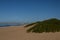 Small Aeroplane in Sky over Sand Dune with Durban Buildings on Horizon