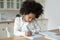 Small african American girl prepare homework at home