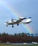 Small aircraft landing with rainbow sky