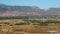 Small aircraft taking off with green hills and mountains in the background, Greece