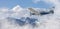 Small Airplane flying near Sky Pilot Mountain covered in Snow. Adventure Composite