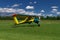 Small airplane landing or taking off on a grass air strip with motion blur to convey movement