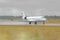 Small Airplane landing in a wet runway during the rain at the airport.
