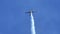 Small airplane moves upward releasing white aerobatics smoke stunt flying