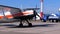 Small airplane with propeller standing on the aircraft parking near the hangar on a small airfield