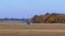 Small airplane with a rotating propeller is moving along a runway with a ground coating