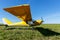 small airplane waiting on field, Yellow plane on the grass.