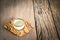 Small alcohol glass with plate on a wooden table background.