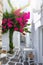 Small alley with colourful bougainvillea flowers in the small village of Naousa on Paros