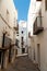 Small alley inside old town center of spanish small town in costa brava region during summer sunny day