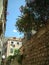 Small alley with stone wall and old buildings in Croatia