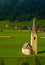 Small Alpine Church in Green Field