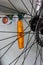 Small amber bicycle reflector mounted on the wheel spokes close up shot