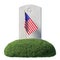 Small American flag and headstone on green grass islet isolated
