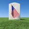 Small American flag and headstone on green grass under blue sky