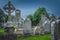 Small ancient cemetery and ruined church tower. Celtic style gravestones