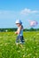 The small angry girl on a meadow