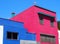 Small angular pink and blue modern concrete houses in Spain