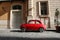 Small Antique Car parked on cobble stone road