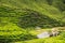 Small arbor and human made waterfall surrounded by hills