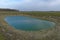 Small artificial shallow reservoir. A beautifully colored pond. Spring landscape