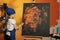 Small artist painting masterpiece with orange