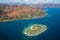 A small atoll islet with heart shaped coral reef off the east coast of Grande Terre island of New Caledonia, Melanesia, Oceania.