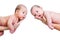 Small babies twins on parental hands isolated