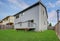 Small back yard with green grass and wooden fence