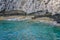 Small backwater surrounded by a stone cliff with azure water in Cyprus