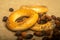 Small bagels and dried rosehip fruit scattered on a homespun cloth with a rough texture. Close up