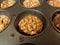 Small baked pecan pies in metal baking tin