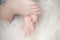 Small bare feet of a little baby girl or boy. Sleeping newborn child.