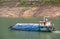 Small barge with blue tarp on Yangtze River Xiling Gorge, Xiangxicun, China