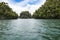 Small barren chalk islands overgrown with tropical plants, Indonesia