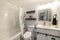 Small bathroom interior with dark and white theme creating a minimalist design