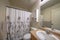 Small bathroom interior with decorative printed gray floral shower curtain