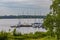 Small bay full of boats and ferries at coast of big lake at sunny morning