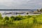 Small bay full of boats and ferries at coast of big lake at sunny morning