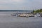 Small bay full of boats and ferries at coast of big lake at sunny morning