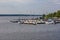 Small bay full of boats and ferries at coast of big lake at sunny morning