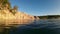 A small beach by a picturesque lake, illuminated by the morning sun