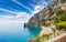Small beach on rocky shore near Positano on Amalfi Coast in Campania, Italy